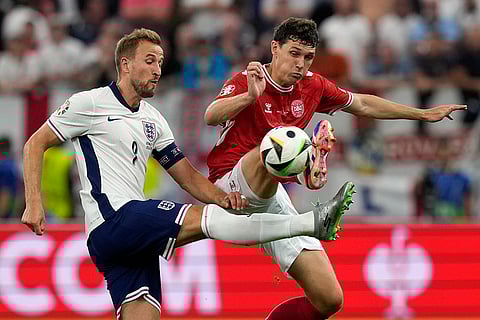 Harry Kane challenges with Andreas Christensen